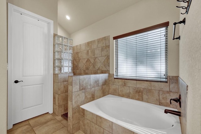 bathroom with tile patterned floors, independent shower and bath, and vaulted ceiling