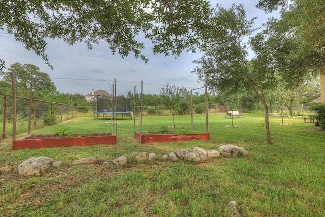 exterior space featuring a yard and a trampoline