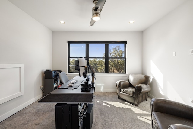 carpeted home office with ceiling fan