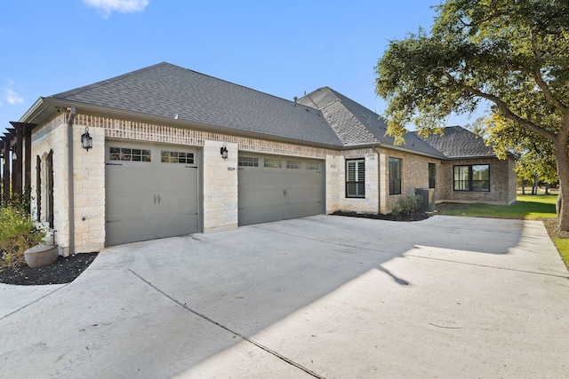 view of front of property with a garage and cooling unit