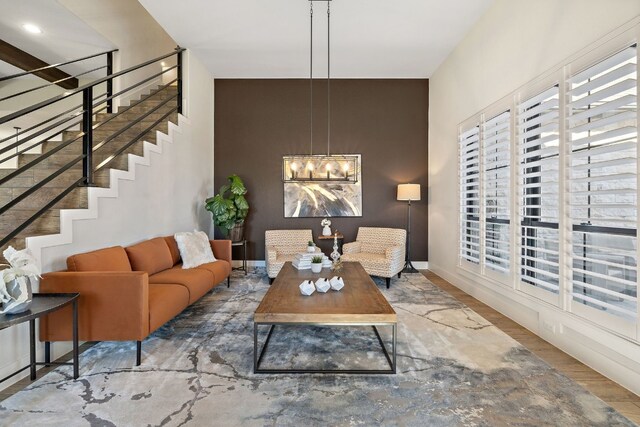 living room featuring a chandelier and wood-type flooring