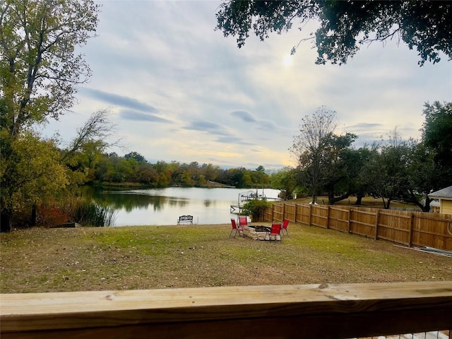 view of yard featuring a fire pit and a water view