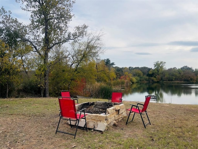 view of yard with a water view and a fire pit