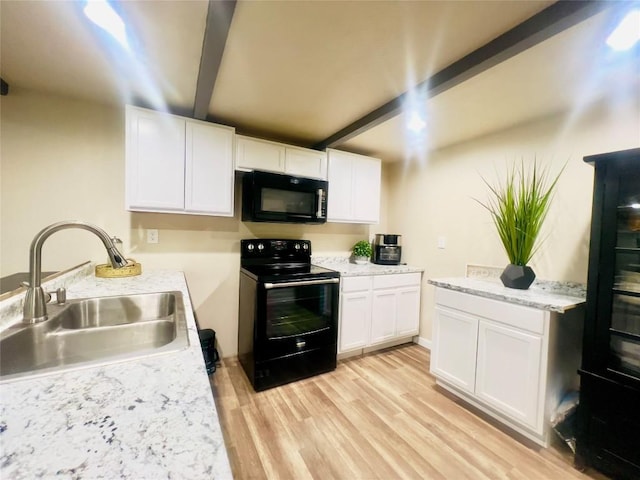 kitchen featuring beam ceiling, sink, white cabinets, and black appliances