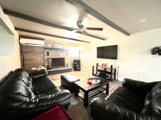 1342 Moose Trl, Kingsland, TX 78639 - living area featuring a wall mounted air conditioner, beam ceiling, wood finished floors, a fireplace, and ceiling fan