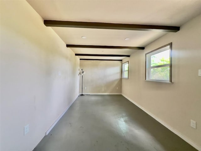 1342 Moose Trl, Kingsland, TX 78639 - empty room featuring beam ceiling, finished concrete floors, and baseboards