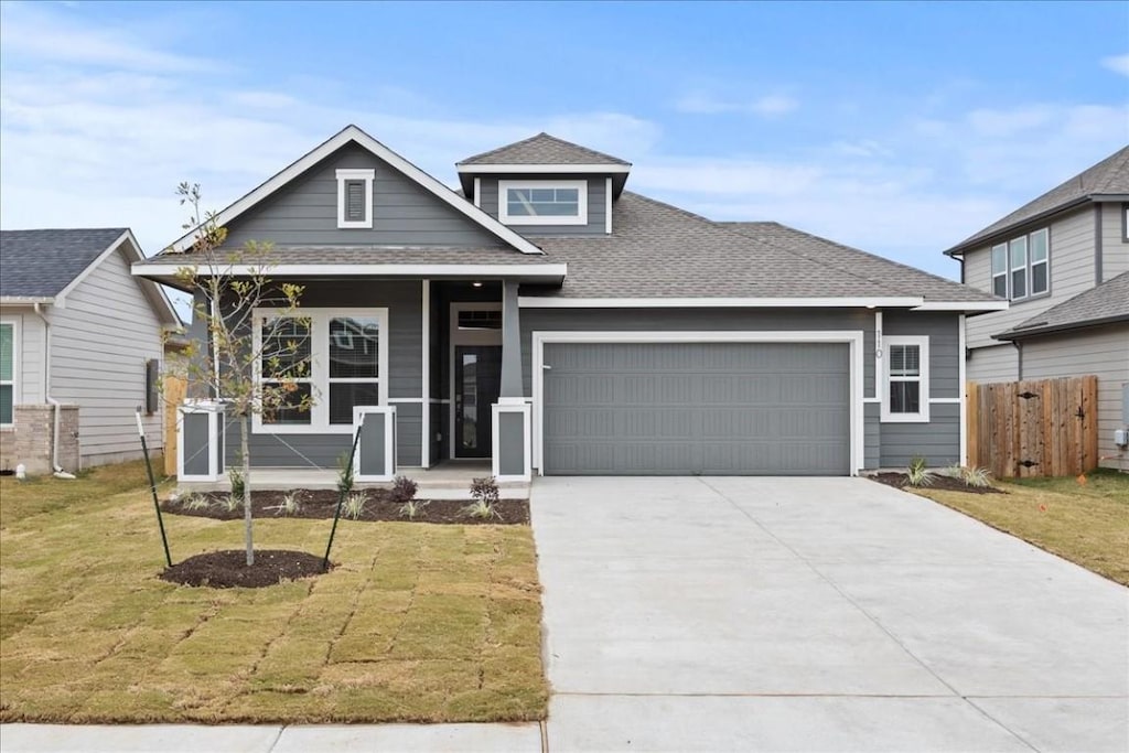 view of front of house featuring a front yard and a garage