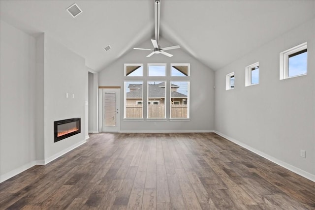 unfurnished living room featuring dark hardwood / wood-style flooring, vaulted ceiling, and ceiling fan