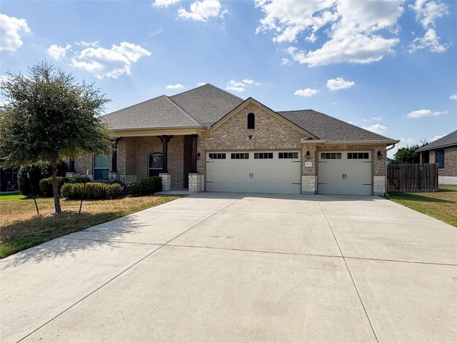 view of front facade featuring a front yard, a porch, and a garage