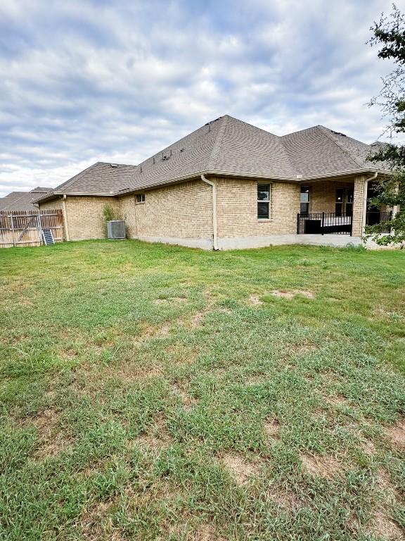 rear view of house with a patio area and a yard