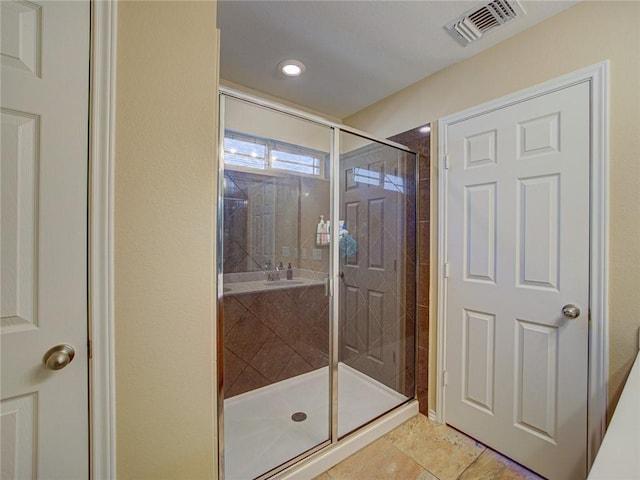 bathroom featuring a shower with door