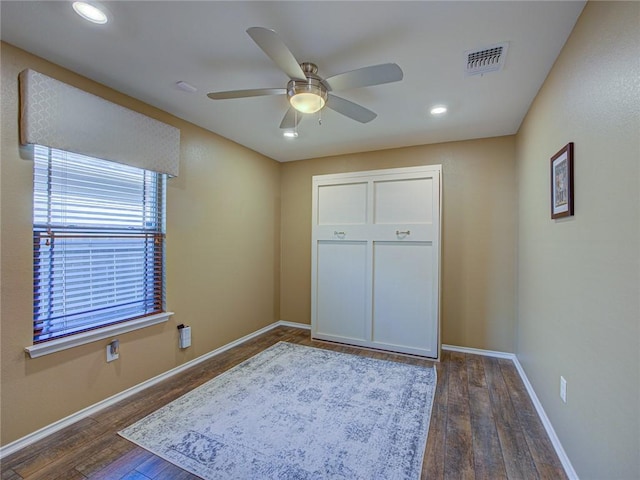 bedroom with ceiling fan and dark hardwood / wood-style floors