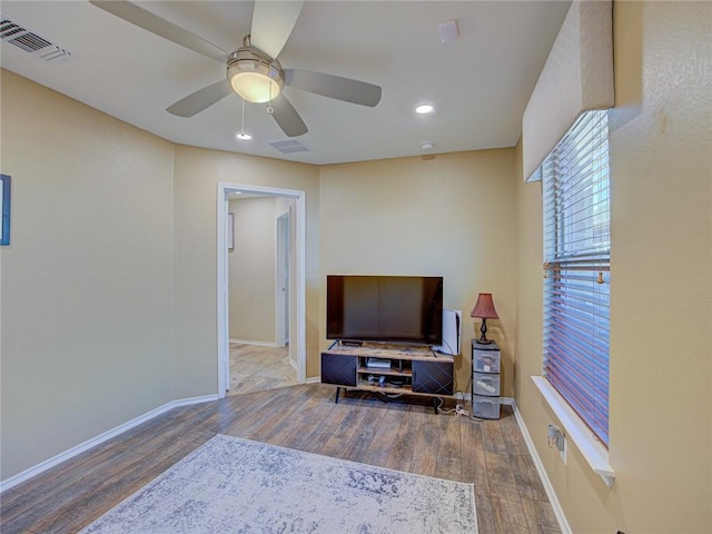 living room with hardwood / wood-style floors and ceiling fan