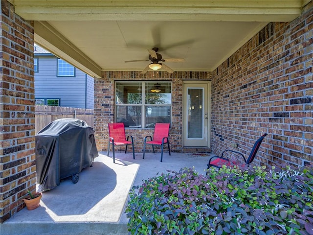 view of patio with area for grilling and ceiling fan