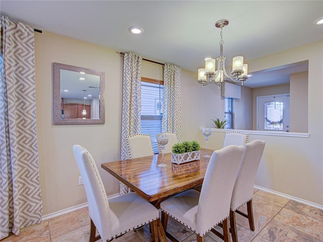 dining space with a healthy amount of sunlight and a notable chandelier