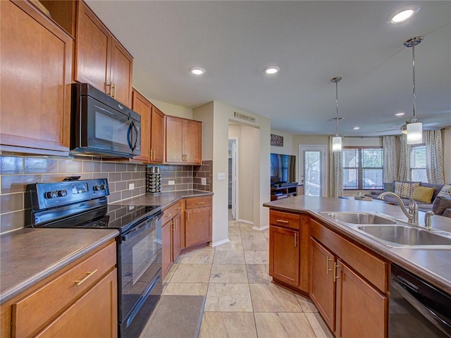 kitchen with decorative backsplash, ceiling fan, sink, black appliances, and hanging light fixtures