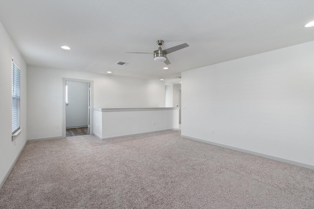 spare room with carpet and ceiling fan