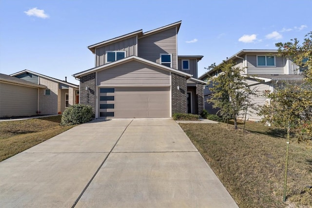 10400 Fulton Ave, Austin, TX 78754 - contemporary house featuring driveway, board and batten siding, an attached garage, and brick siding