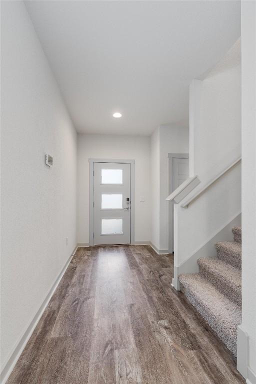 10400 Fulton Ave, Austin, TX 78754 - entryway with wood finished floors, stairs, baseboards, and recessed lighting