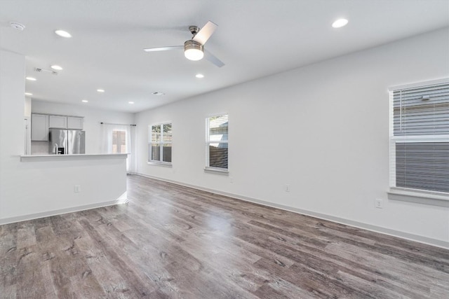 10400 Fulton Ave, Austin, TX 78754 - unfurnished living room featuring wood finished floors, a ceiling fan, recessed lighting, and baseboards