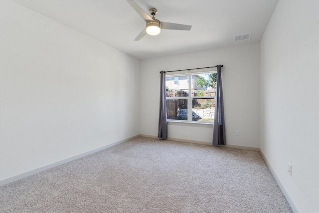 spare room featuring ceiling fan and carpet floors