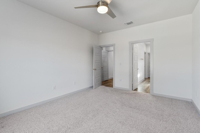 unfurnished bedroom featuring ceiling fan, light colored carpet, and a closet