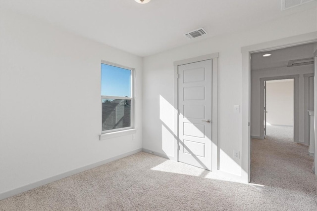 spare room with light colored carpet