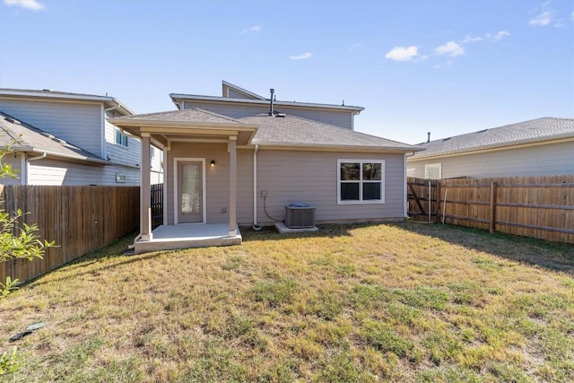 back of house featuring a yard, a patio area, and central air condition unit