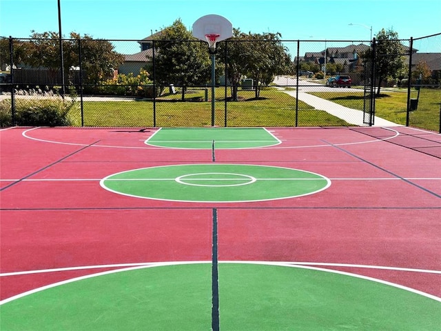 view of sport court featuring a lawn