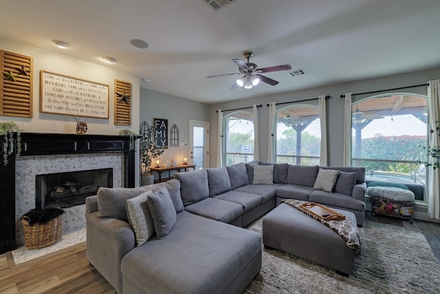 living room featuring hardwood / wood-style flooring and ceiling fan