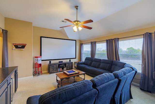 carpeted cinema room with vaulted ceiling and ceiling fan