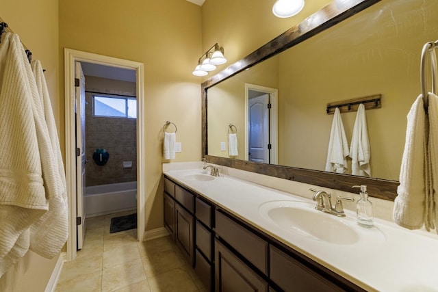 bathroom featuring tile patterned floors, a bath, double vanity, and a sink