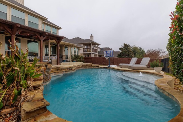 view of pool with a patio area and pool water feature