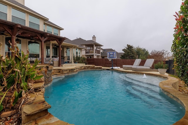 view of swimming pool with a ceiling fan, a patio area, a fenced backyard, and a fenced in pool