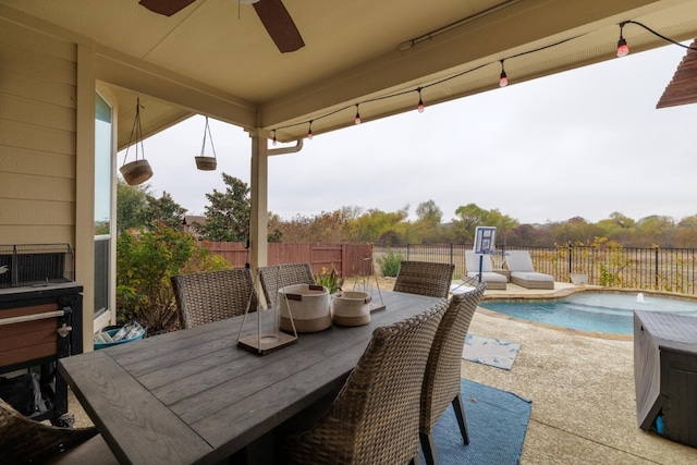 view of patio with a fenced in pool, outdoor dining area, a fenced backyard, and ceiling fan