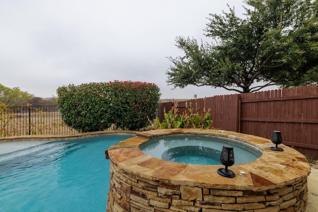 view of pool featuring a fenced in pool, an in ground hot tub, and a fenced backyard