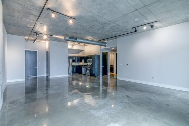 garage with stainless steel refrigerator and black refrigerator