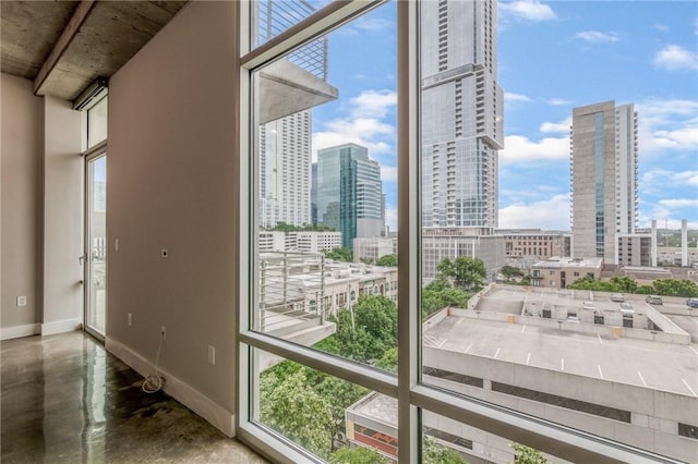 doorway with a wealth of natural light and concrete floors