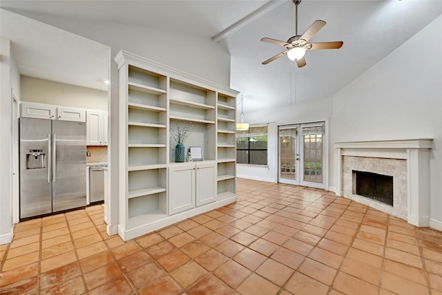 unfurnished living room with ceiling fan, french doors, light tile patterned floors, and lofted ceiling