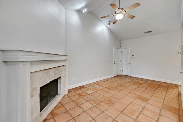 unfurnished living room featuring beam ceiling, high vaulted ceiling, ceiling fan, and a tiled fireplace