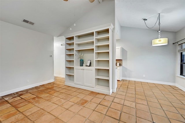 interior space featuring light tile patterned floors, white cabinetry, hanging light fixtures, and ceiling fan