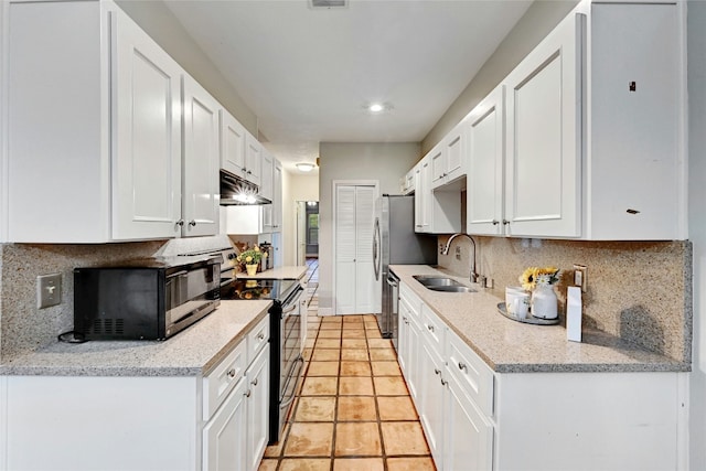 kitchen with backsplash, white cabinets, black appliances, sink, and light stone counters