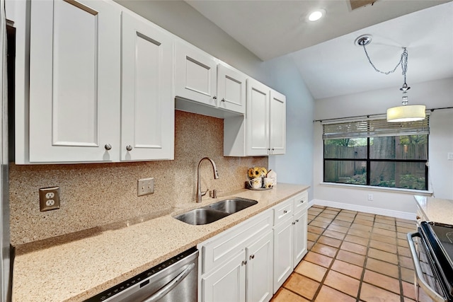 kitchen with backsplash, white cabinets, sink, vaulted ceiling, and decorative light fixtures