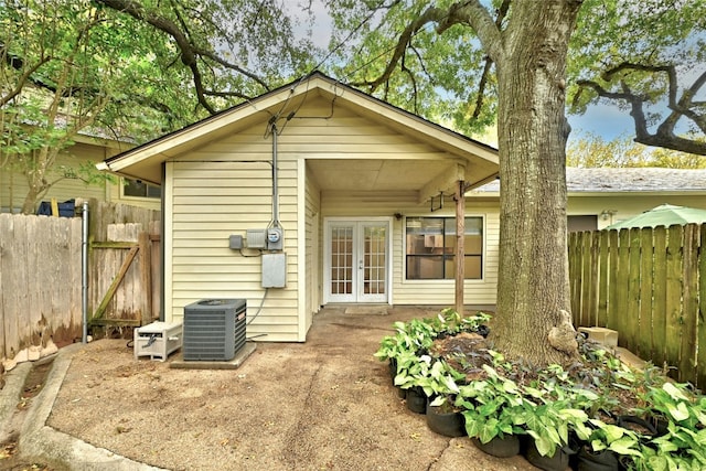 back of property featuring cooling unit and french doors