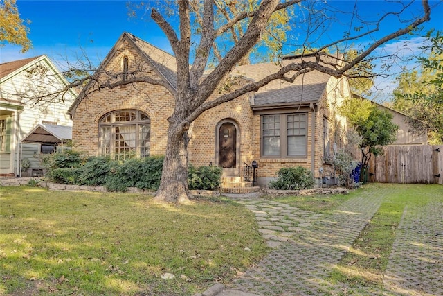 tudor house featuring a front lawn