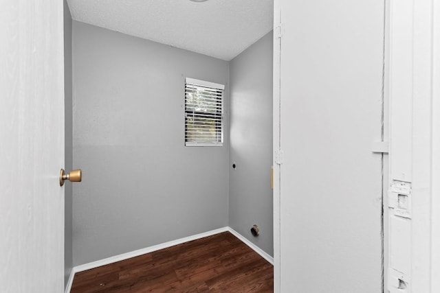 washroom with a textured ceiling, hardwood / wood-style flooring, and electric dryer hookup