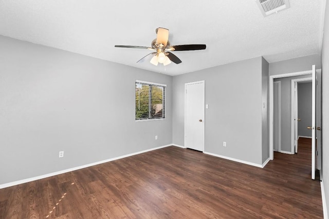 unfurnished room featuring ceiling fan and dark wood-type flooring