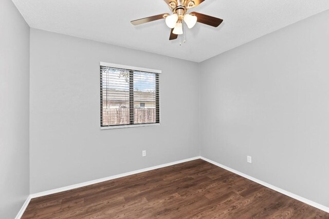 empty room featuring dark hardwood / wood-style floors and ceiling fan