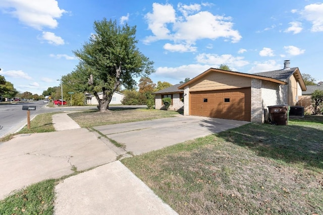 view of side of home featuring central AC, a yard, and a garage