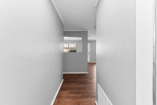 hallway featuring dark hardwood / wood-style floors and ornamental molding